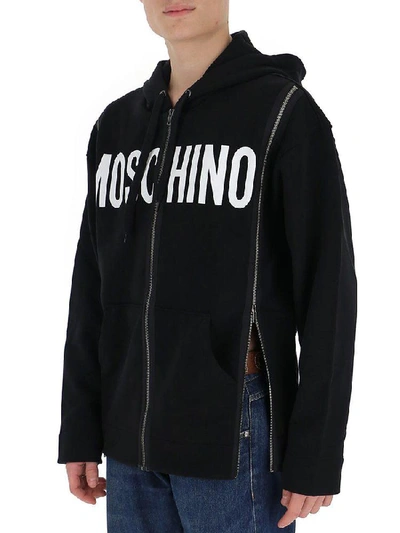 Shop Moschino Zipped Logo Print Hoodie In Black