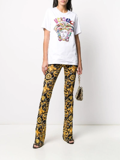 Shop Versace Pants Jersey In Nero/oro