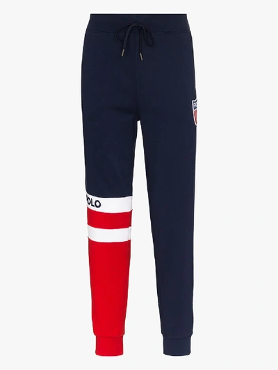 Shop Polo Ralph Lauren Striped Logo Track Pants In Blue