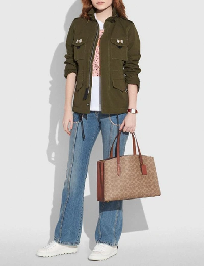 Shop Coach Charlie Carryall In Signature Canvas In Rust/brass