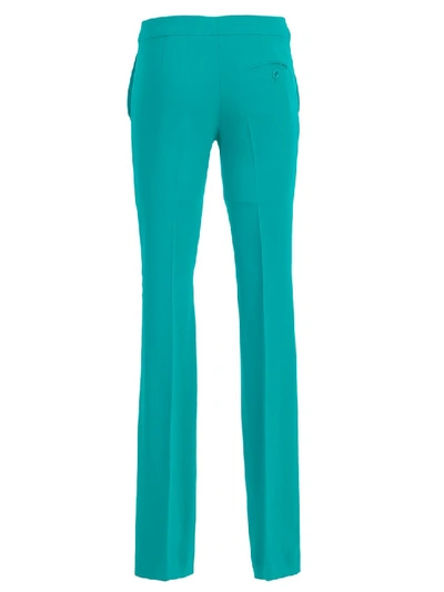 Shop Moschino Flared Pants In Green