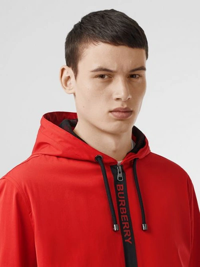 Shop Burberry Logo Detail Nylon Cotton Twill Hooded Jacket In Bright Red