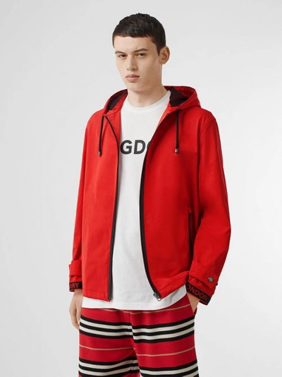 Shop Burberry Logo Detail Nylon Cotton Twill Hooded Jacket In Bright Red