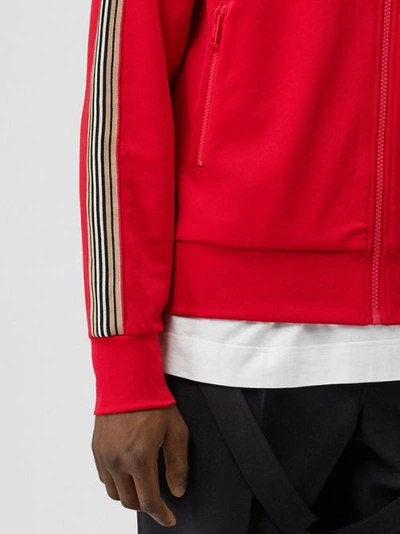 Shop Burberry Icon Stripe Detail Funnel Neck Track Top In Bright Red