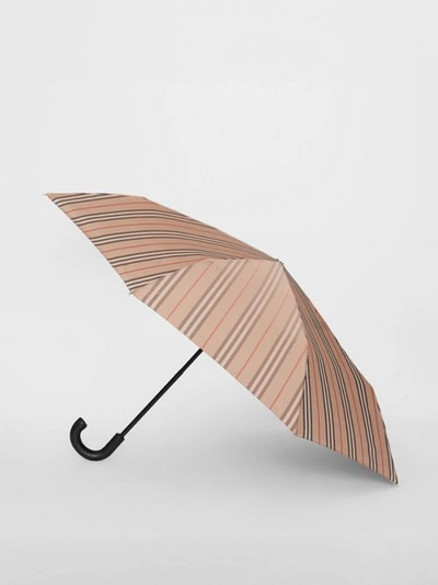 Shop Burberry Icon Stripe Folding Umbrella In Camel