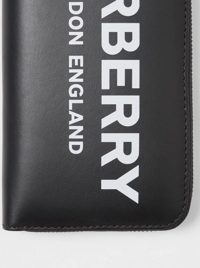 Shop Burberry Logo Print Leather Ziparound Wallet In Black