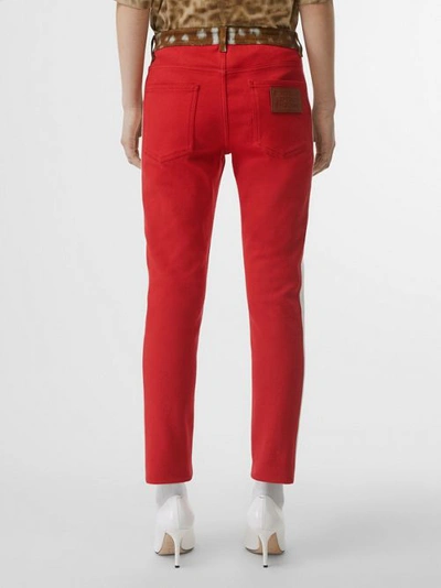 Shop Burberry Straight Fit Deer Print Trim Japanese Denim Jeans In Bright Red