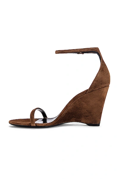 Shop Saint Laurent Lila Wedge Sandals In Land