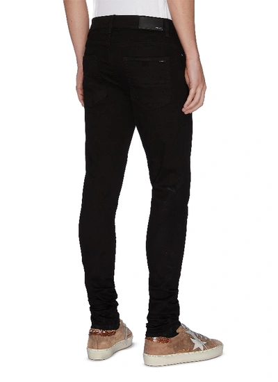 Shop Amiri Stacked Jeans In Black