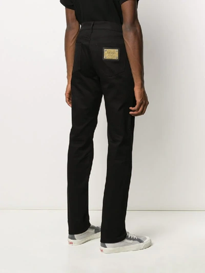 Shop Moschino Slim Regular Length Jeans In Black