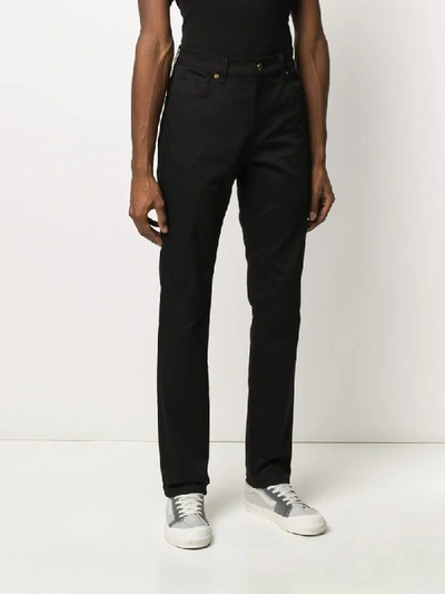 Shop Moschino Slim Regular Length Jeans In Black