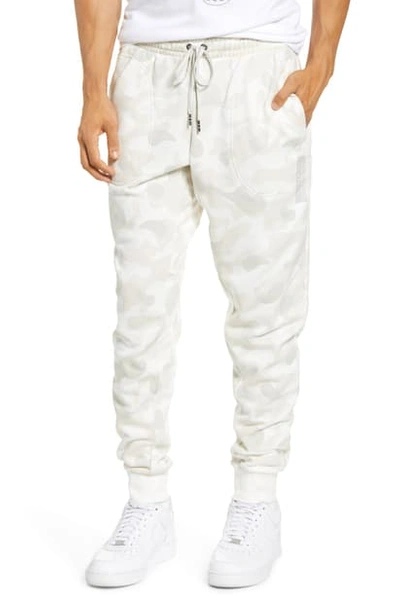 Shop Nike Sportswear Print French Terry Sweatpants In Sail/ Light Bone/ White