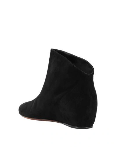 Shop Alaïa Ankle Boots In Black