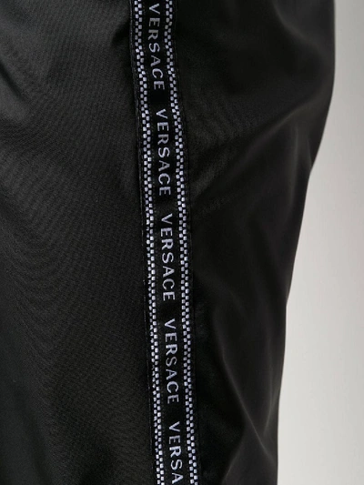 Shop Versace Black Logo Tape Track Pants