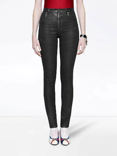 Shop Gucci Coated Denim Skinny Jeans In Black