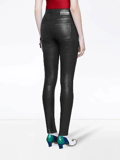 Shop Gucci Coated Denim Skinny Jeans In Black