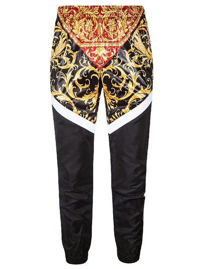 Shop Versace Trousers In Red