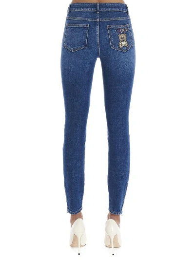 Shop Moschino Teddy Embellished Skinny Jeans In Blue
