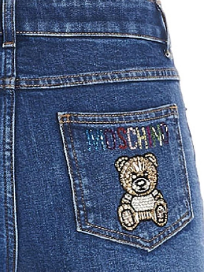 Shop Moschino Teddy Embellished Skinny Jeans In Blue