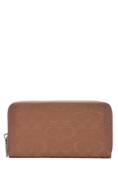 Shop Coach Monogram Embossed Zipped Wallet In Brown