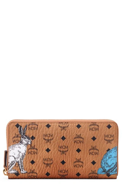 Shop Mcm Hide & Seek Rabbit Visetos Zip Around Coated Canvas Wallet In Cognac