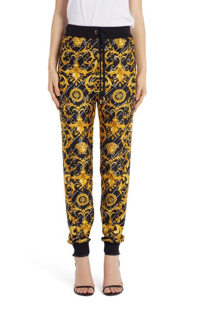 Shop Versace Barcocco Signature Print Joggers In Black/gold