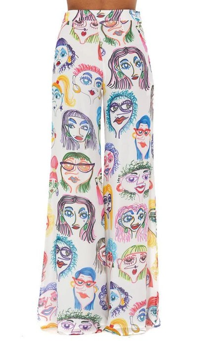 Shop Moschino Faces Printed Trousers In Multi