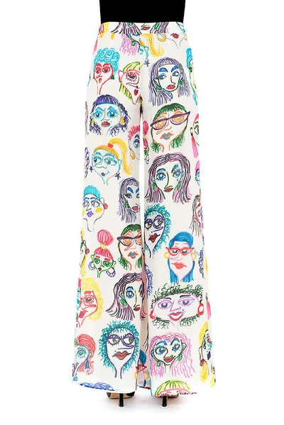 Shop Moschino Faces Printed Trousers In Multi