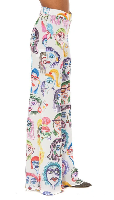 Shop Moschino Faces Printed Trousers In Multi
