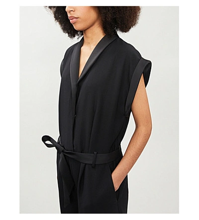 Shop Frame Wrap-over Crepe Jumpsuit In Noir