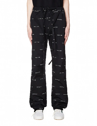 Shop Fear Of God All Over Logo Printed Baggy Trousers In White