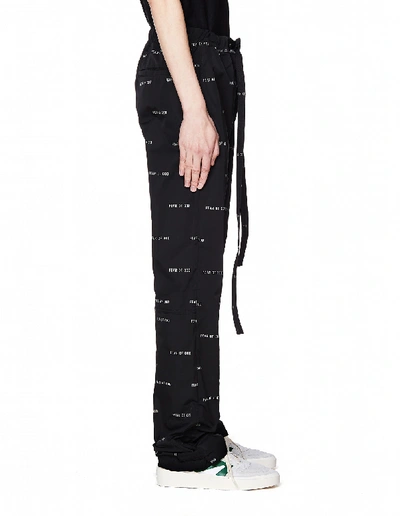 Shop Fear Of God All Over Logo Printed Baggy Trousers In White