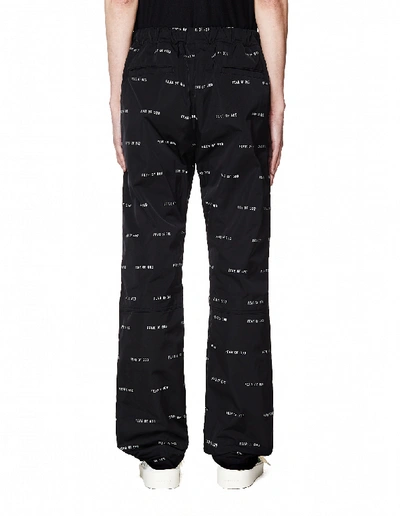 Shop Fear Of God All Over Logo Printed Baggy Trousers In White