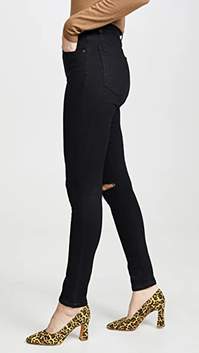 Shop Reformation High & Skinny Jeans In Faded Black Destroyed