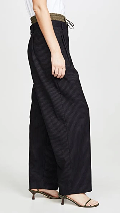 Shop Monse Pinstripe Pleated Trousers In Black Olive