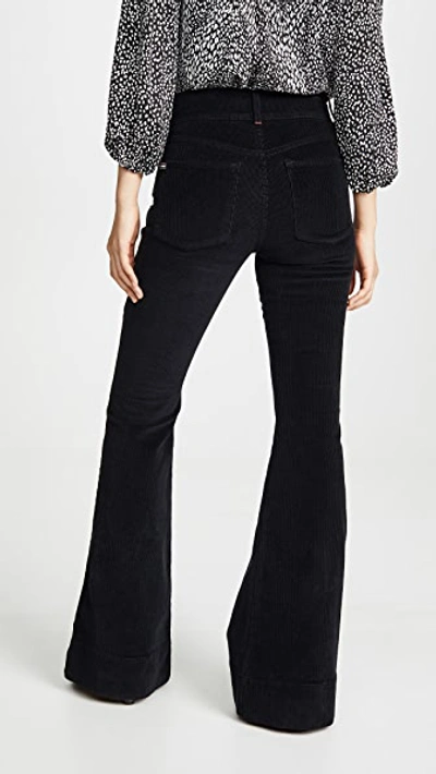 Shop Alice And Olivia Beautiful Exposed Button Bell Jeans In Black