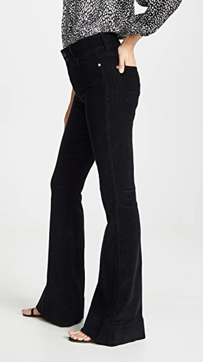 Shop Alice And Olivia Beautiful Exposed Button Bell Jeans In Black