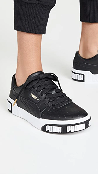 Shop Puma Cali Bold Sneakers In  Black/metallic Gold