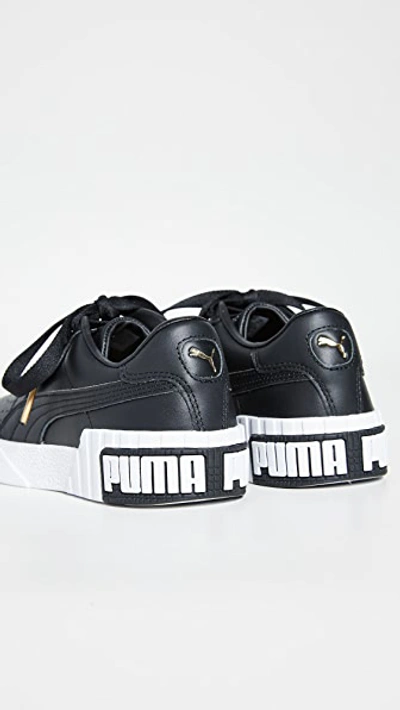 Shop Puma Cali Bold Sneakers In  Black/metallic Gold