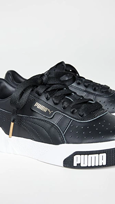 Shop Puma Cali Bold Sneakers In  Black/metallic Gold