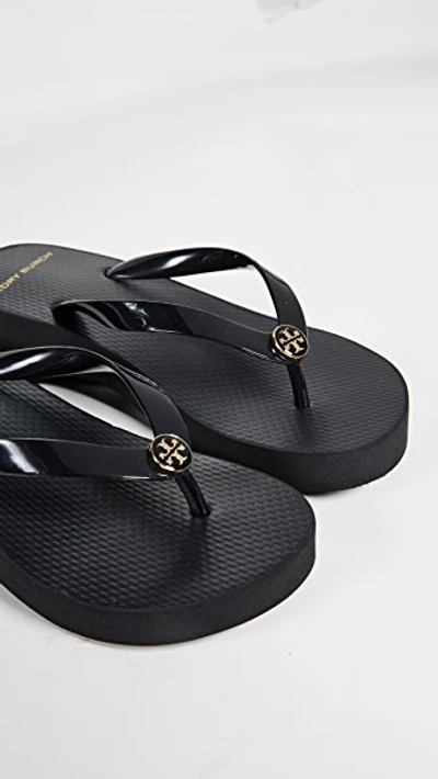 Shop Tory Burch Cutout Wedge Flip Flops In Black/black