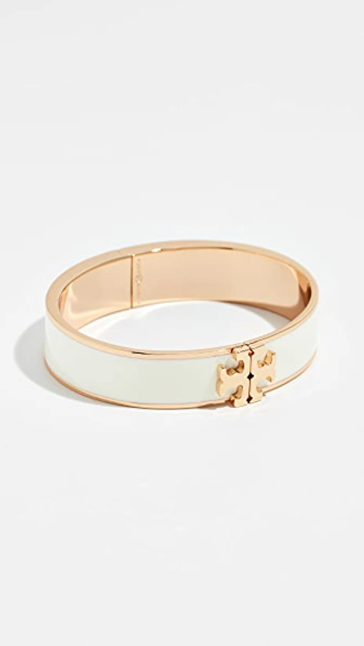 Shop Tory Burch Raised Logo Enamel Hinged Bracelet In New Ivory/tory Gold