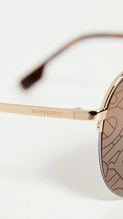 Shop Burberry Ferry Sunglasses In Gold/brown Tampo Tb