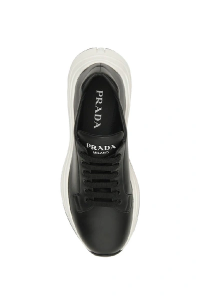 Shop Prada Logo Embossed Sneakers In Black