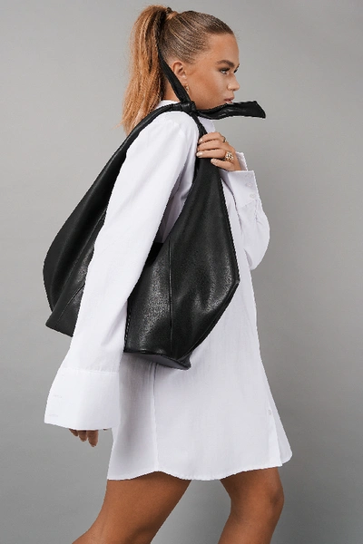 HANNA SCHÖNBERG X NA-KD KNOT DETAIL FAUX LEATHER BAG - BLACK 