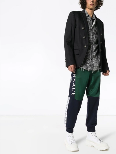 Shop Versace Print Tracksuit Trousers In Green