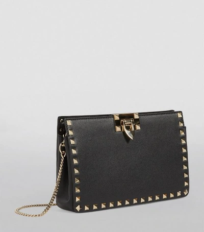 Shop Valentino Garavani Leather Rockstud Clutch Bag