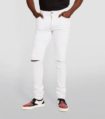 Shop Amiri Skinny Knee-slash Jeans