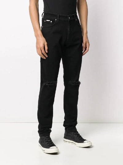 Shop Represent Distressed Skinny Jeans In Black