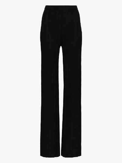 Shop Totême Cour Ribbed Knit Trousers In Black